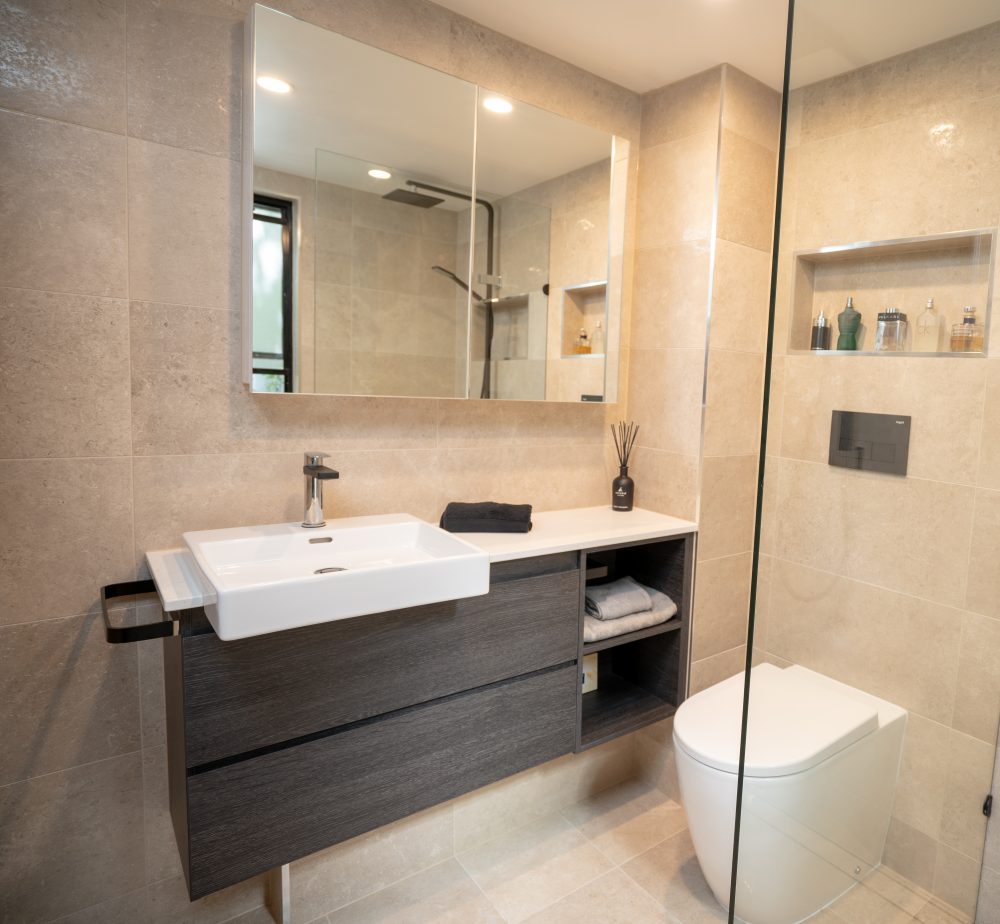 Brisbane Bathroom Company Small Bathroom Renovation with dark wood vanity and large bathroom mirror located in Bowen Hills