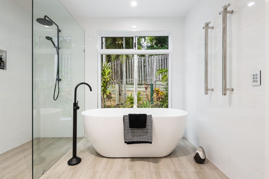 Brisbane Bathroom Company Modern Small Bathroom Renovation with large white bath tub and black floor mounted faucet