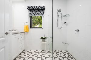 Brisbane Bathroom Company Modern Small Bathroom Renovation with shower space and black and tile floor tile